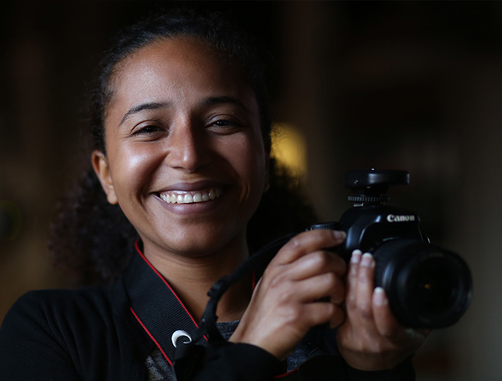 Student holding a Digital camera